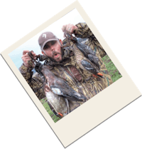 a man holding up a photo of ducks